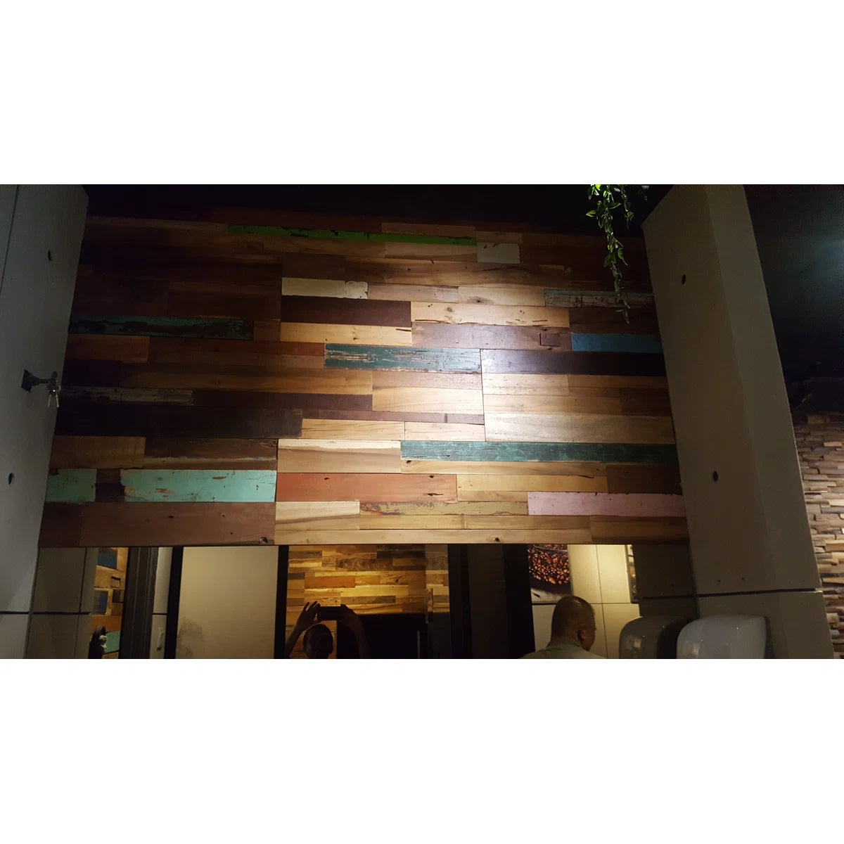 Wooden wall with multicolored planks in a room setting